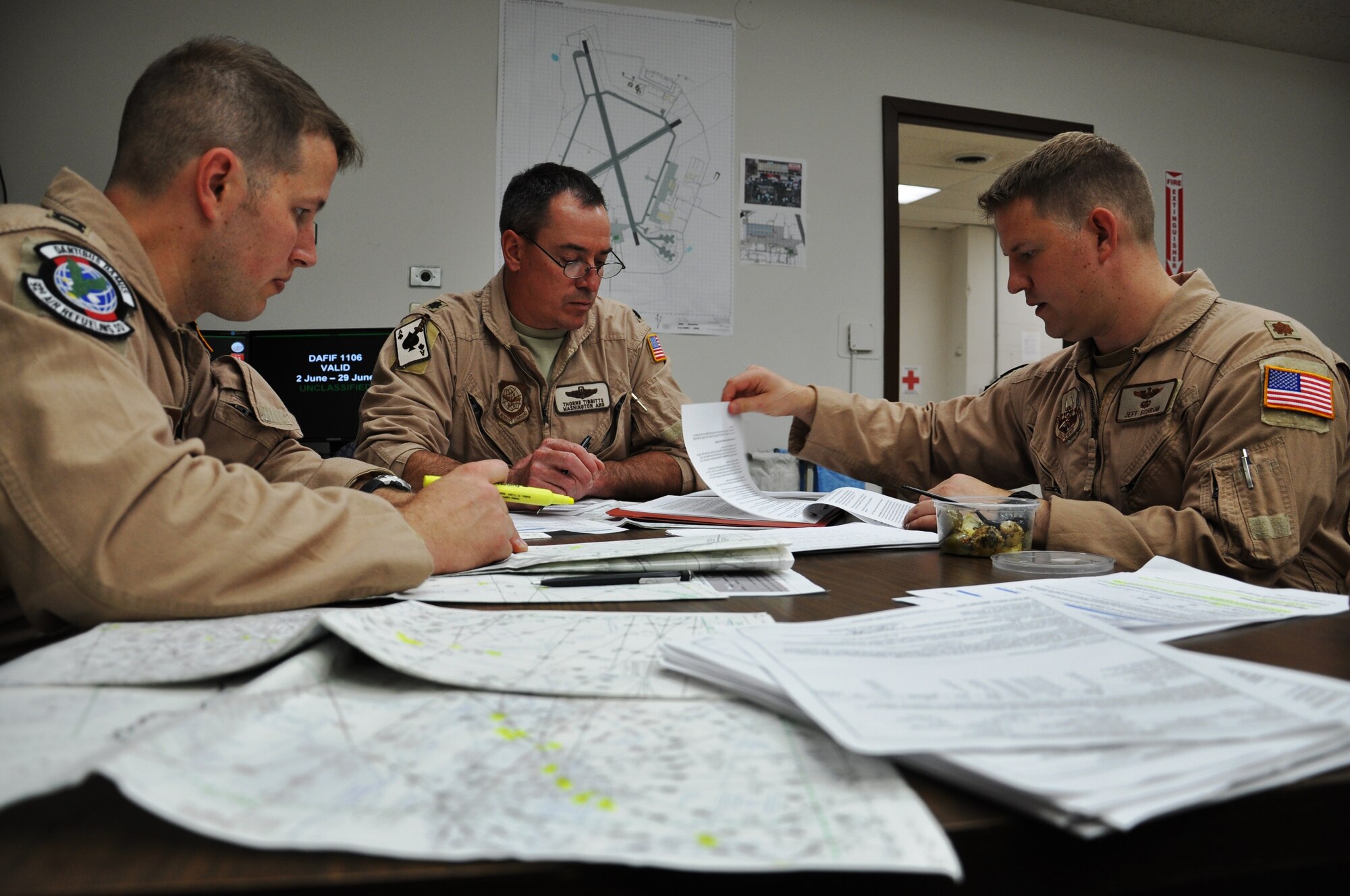KC-135 Stratotanker pilots from Fairchild Air Force Base, Wash., go over mission plans for a historic polar over-flight mission from Washington state to Kyrgyzstan on June 21, 2011.  Included in this photo are: (from left) Capt. Jared Gude, 92nd Air Refueling Squadron; Lt. Col. Thorne Tibbitts, 141st Aircraft Maintenance Generation Squadron; and Maj. Jeff Schrum, 92nd ARS.   The KC-135 Stratotanker flew over the Arctic Circle and the North Pole for the first time June 21 to 22 as part of an “iron swap” mission along a new, more efficient route from Moses Lake, Wash., to Manas Air Base, Kyrgyzstan. (U.S. Air Force Photo/Capt. Kathleen Ferrero)