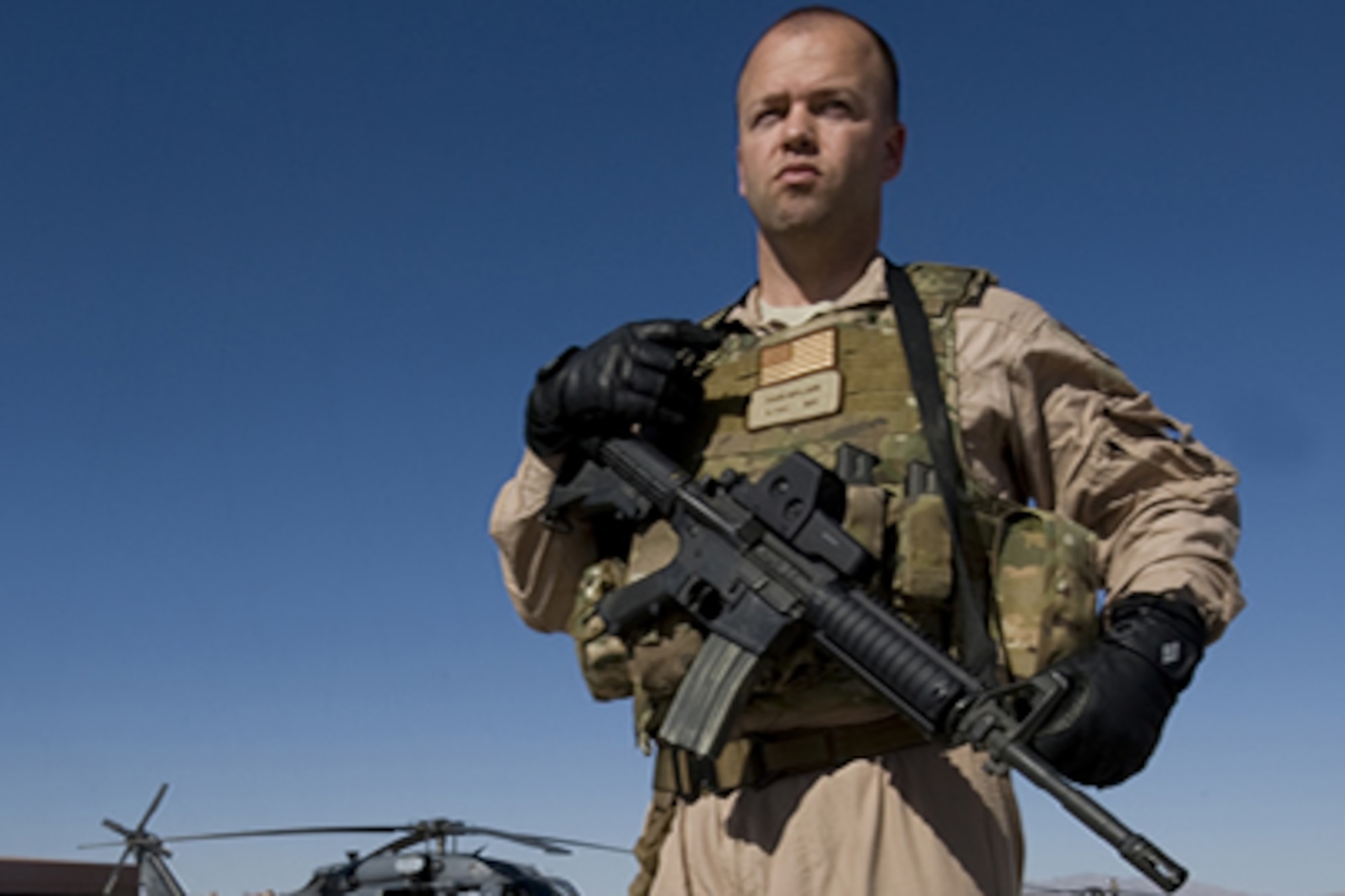 Staff Sgt. David Mullikin stands in front of an HH-60 Pavehawk in full
operational gear at Nellis Air Force Base, Nev., June 23, 2011. Sergeant
Mullikin is a flight engineer assigned to the 66th Rescue Squadron.  He
returned from a tour in Iraq suffering from post-traumatic stress disorder
and got help through the Air Force Wounded Warrior program.  (U.S Air Force
photo/Senior Airman Stephanie Rubi)

