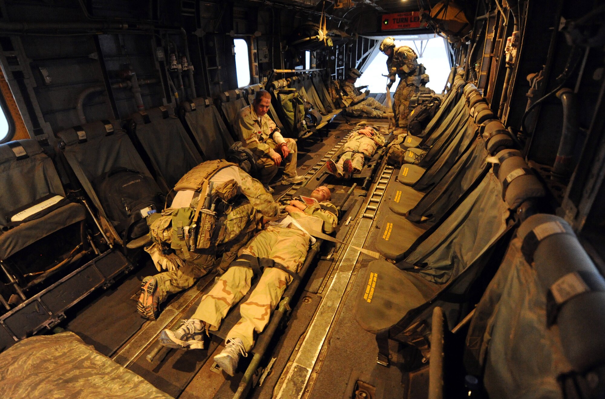 DJIBOUTI, Africa -- U.S. Air Force pararescue jumpers from the 82nd Expeditionary Rescue Squadron secure victims of a mock plane crash to the bed of a U.S. Marine Corps MH-53 helicopter for transport June 16. The scenario was part of a joint training exercise involving all branches of the U.S. military stationed at Camp Lemonnier, Djibouti. The 82nd ERQS is made up mostly of airmen from the 304th Rescue Squadron, Air Force Reserves, Portland, Oregon. (U.S. Air Force photo by Staff Sgt. Austin M. May)