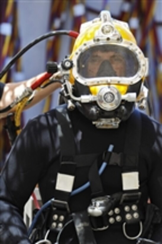 Chief Petty Officer Billy Goold, assigned to Commander, Task Group 56.1, prepares for a dive salvage project in Umm Qasr, Iraq, on June 12, 2011.  Commander, Task Group 56.1, U.S. Army, and Iraqi navy divers are working to raise and remove a sunken pier at the port of Umm Qasr, Iraq.  Commander, Task Group 56.1 supports maritime security operations and theater security cooperation efforts in the U.S. 5th Fleet area of responsibility.   