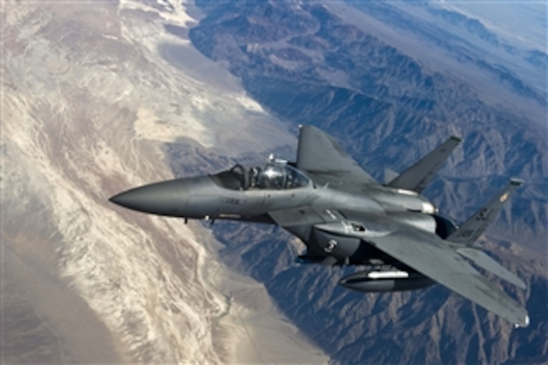 A U.S. Air Force F-15E Strike Eagle aircraft with the 335th Fighter Squadron pulls alongside a KC-135 Stratotanker aircraft after refueling during Green Flag-West 11-08 over Nellis Air Force Base, Nev., on June 22, 2011.  Conducted by the 549th Combat Training Squadron at Nellis Air Force Base Nev., and the 12th Combat Training Squadron at Fort Irwin, Calif., Green Flag-West provides a realistic close-air support training environment for airmen and soldiers preparing to deploy in support of combat operations.  