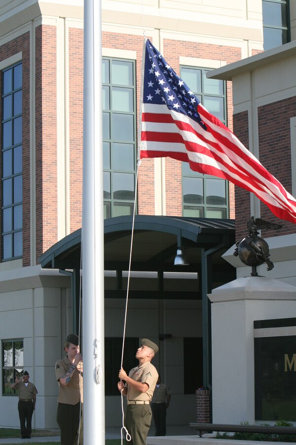 NEW ORLEANS – Lance Cpl. Jose Castilla and Sgt. Christina Berberena raise the national ensign for the first time aboard Marine Corps Support Facility New Orleans prior to the dedication ceremony of the Joseph J. McCarthy Building June 27.  The more than 400,000 square-foot building was named in honor of Medal of Honor recipient Joseph J. McCarthy and is the new headquarters for Marine Forces Reserve and Marine Forces North.