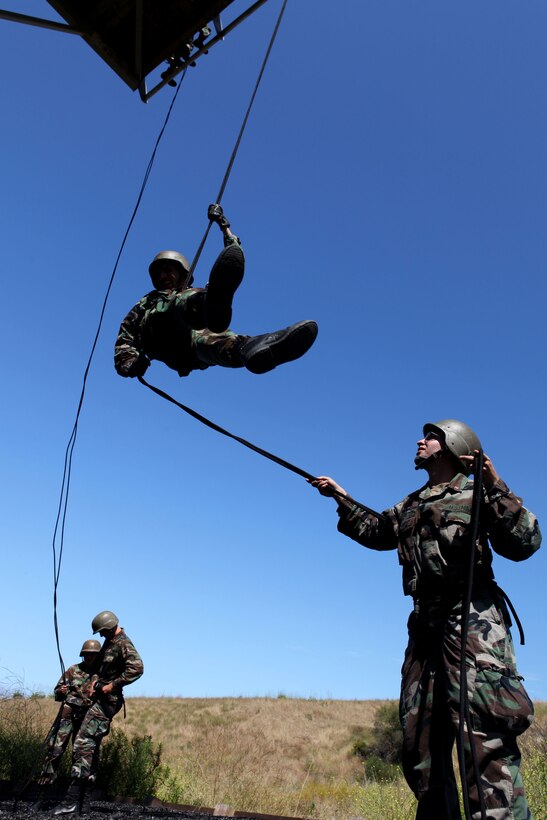 A group of midshipmen conduct Helicopter Rope Suspension Techniques training at the 53 area rappel tower here, June 28. The midshipmen learned how to tie proper knots and make a seat using rope to rappel off the tower.