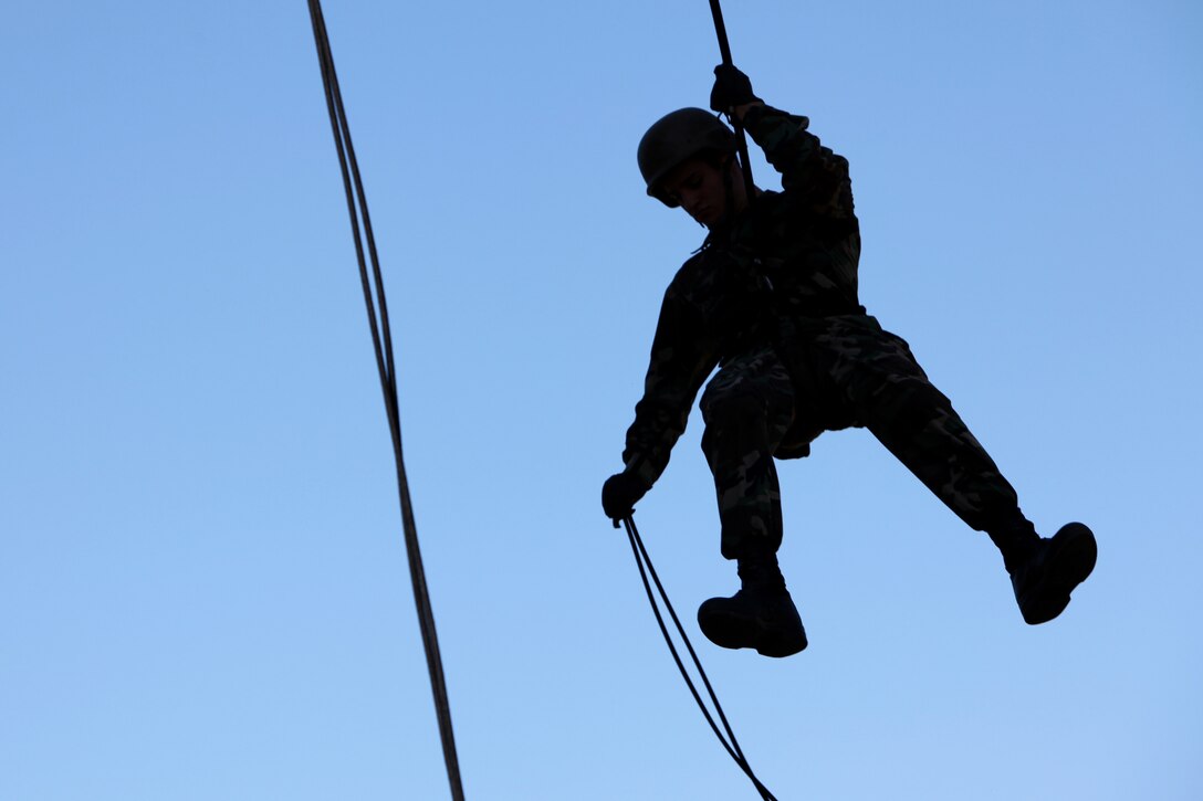 Midshipman Miles McGee, 21, from Mandeville, La., rappels down the 53 area rappel tower here, June 28. A group of midshipmen from the U.S. Naval Academy learned basic rappelling techniques with help from the Special Operations Training Group.