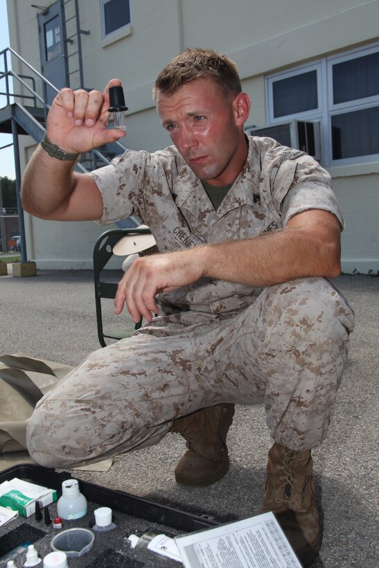 Cpl. Matthew L. Cheney does his job as a water support technician with Marine Wing Support Squadron 274.