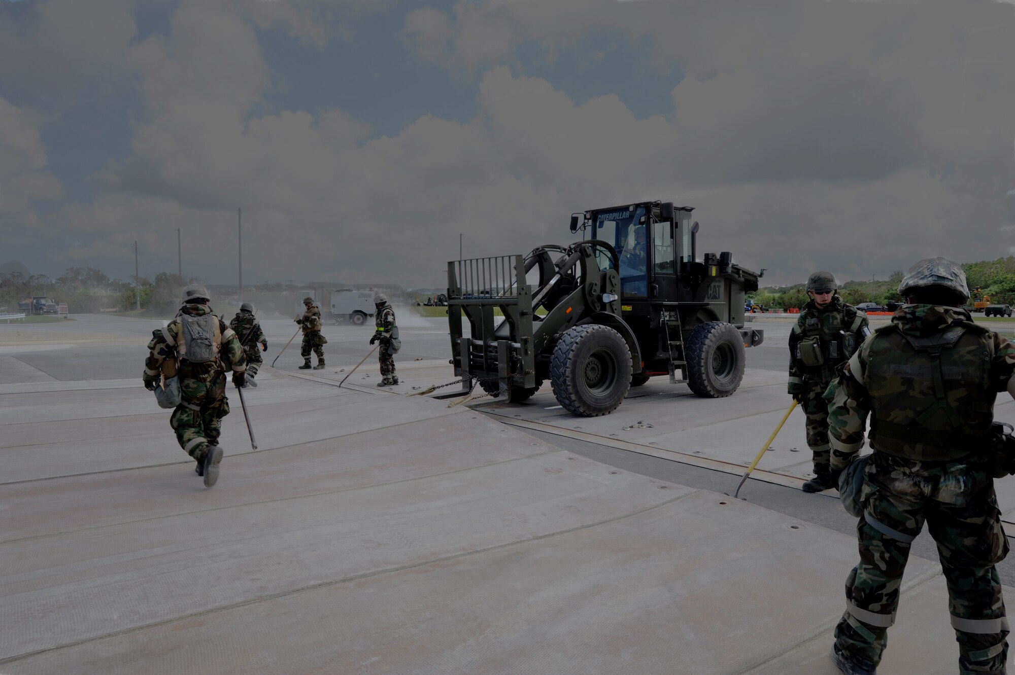 Civil engineers prepare to lift a fiberglass mat onto a forklift during Silver Flag 11-06 at Kadena Air Base, Japan, June 28. Approximately 120 Airmen, Sailors and Marines attended the Det. 1 554th Rapid Engineer Deployable Heavy Operational Repair Squadron Engineer Silver Flag exercise here. (U.S. Air Force photo/Airman 1st Class Jarvie Z. Wallace)