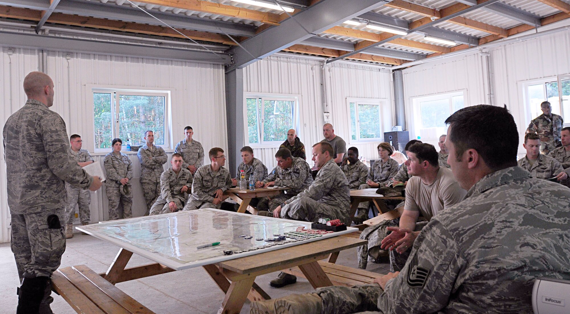 Capt. Ruven Yarbrough leads a daily lessons-learned discussion after the day's training activities June 27, 2011, during Allied Strike 2011, at Grafenwoehr Training Area, Germany. Allied Strike is Europe's premier close-air-support exercise. Captain Yarbrough is the exercise deputy director. He is assigned to the 4th Air Support Operations Group. (U.S. Air Force photo/Airman 1st Class Desiree W. Esposito)