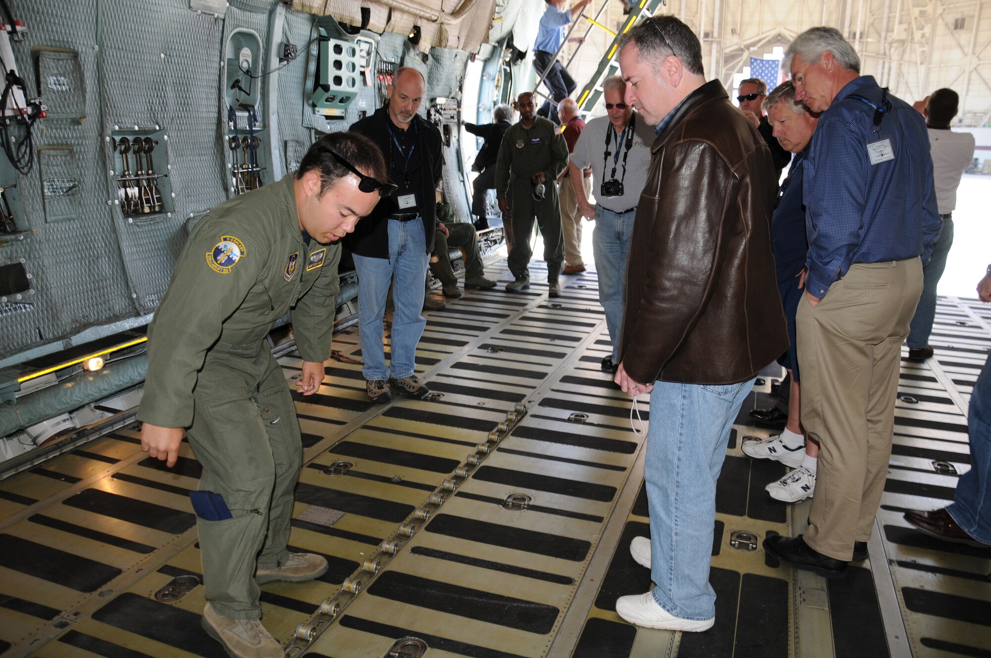 Staff Sgt. Tommy Ishii with the 312th Airlift Squadron, 349th Air Mobility Wing, Travis Air Force Base, demonstrates the capabilities of the C-5 Galaxy to a group of civic leaders June 24.  The 446th Airlift Wing at McChord Field, Wash,. hosted a civic leader tour June 23-24. (U.S. Air Force photo by 2nd Lt. Denise Hauser)
