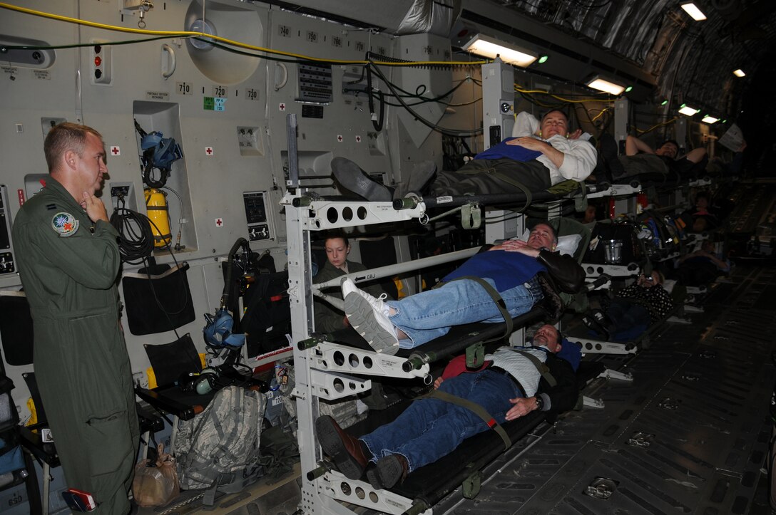 Civic Leaders learn what it is like to take off on a litter on board a C-17 Globemaster III during a civic leader tour.  The 446th Airlift wing hosted a group of 40 civics June 23-24. (U.S. Air Force photo by 2nd Lt. Denise Hauser)