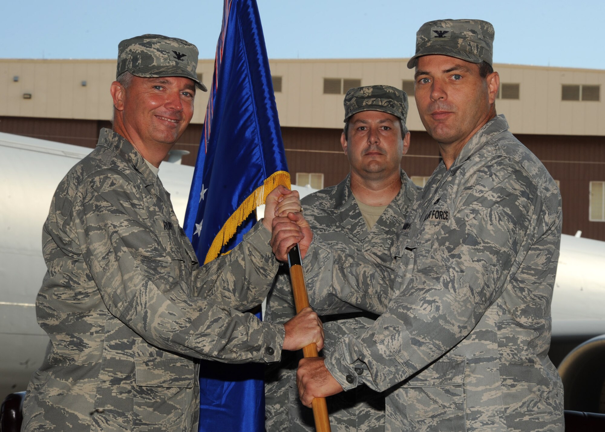 [Left to right] Col. Ricky Rupp, 22nd Air Refueling Wing commander, passes the guidon to Col. Steven Hardy giving him command of the 22nd Maintenance Group during a change of command ceremony June 28, 2011, McConnell Air Force Base, Kan.  The passing of the guidon symbolizes Colonel Hardy’s assumption of command from the outgoing 22nd MXG commander Col. Allen Day.  (U.S. Air Force photo/ Staff Sgt. Dallas Edwards)