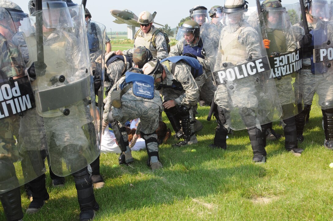 Members of the Nebraska Air National Guard Response Force team extract a simulated protestor during a National Guard Response Force training exercise held at the Nebraska Air National Guard parade grounds on June 5, 2011 in Lincoln, Neb. (Nebraska Air National Guard photo by Senior Airman James Lieth)