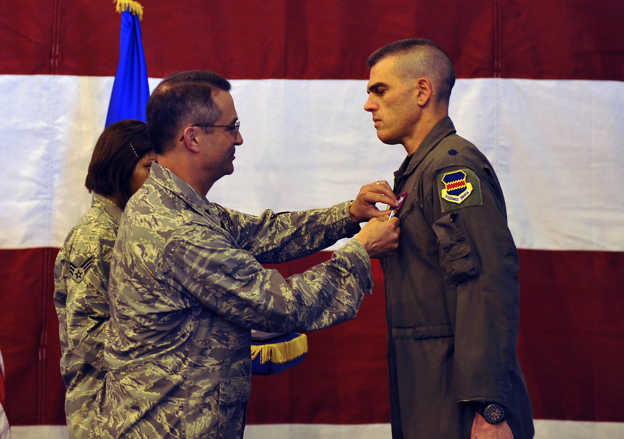 Brig. Gen.  Donald Bacon, 55th Wing commander, presents a Bronze Star to Lt. Col. Richard Rosa, 55th Operations Group deputy commander, during a ceremony inside the Bennie Davis Maintenance Facility, Offutt Air Force Base, Neb., June 14. Colonel Rosa received the decoration for his outstanding year-long service in Southwest Asia as commander of the 763rd Expeditionary Reconnaissance Squadron. U.S. Air Force Photo by Josh Plueger/released.