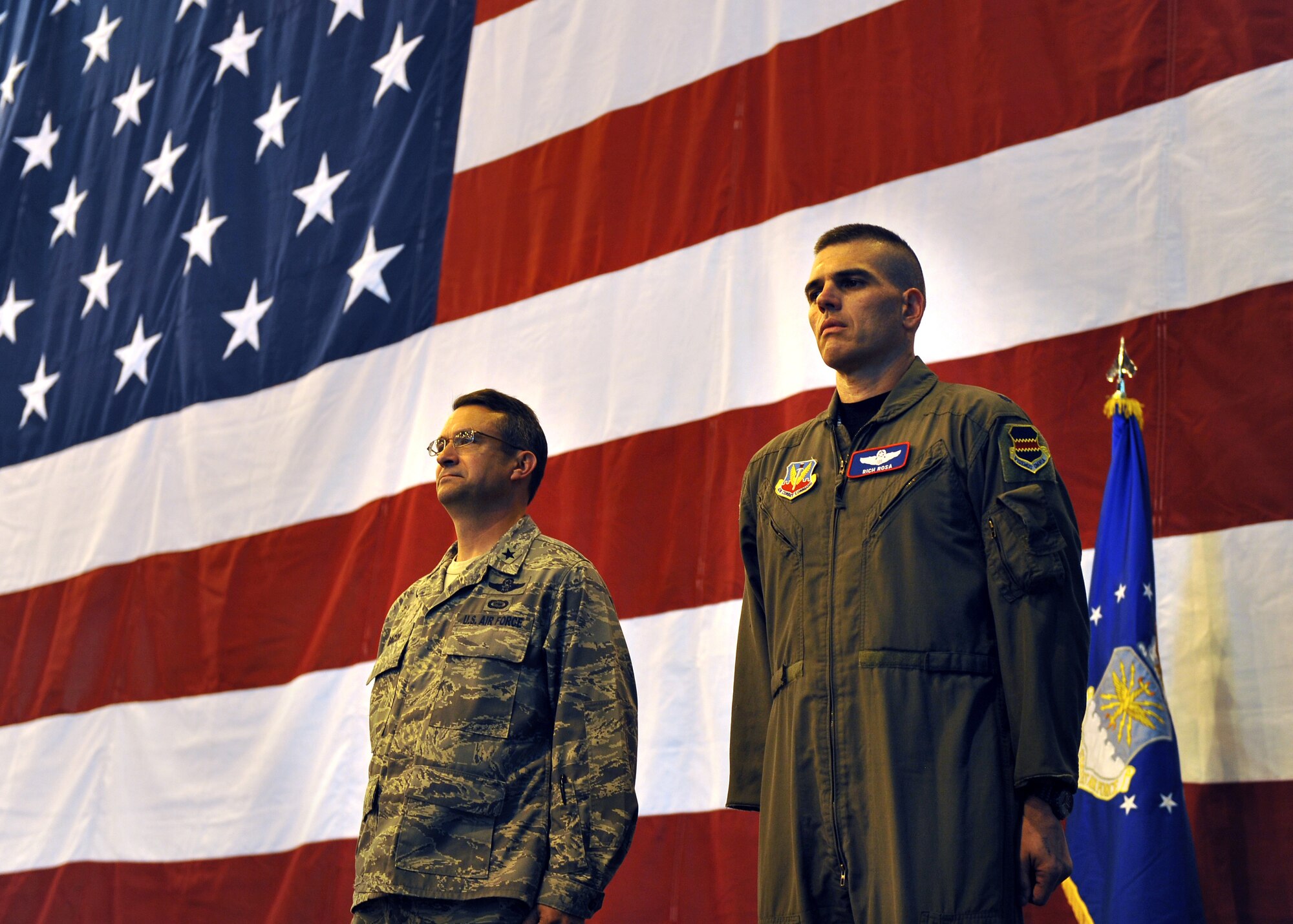 Brig. Gen.  Donald Bacon, 55th Wing commander, stands at attention with Lt. Col. Richard Rosa, 55th Operations Group deputy commander, while a Bronze Star citation is read inside the Bennie Davis Maintenance Facility, Offutt Air Force Base, Neb., June 14. Colonel Rosa received the medal for his outstanding year-long service in Southwest Asia as commander of the 763rd Expeditionary Reconnaissance Squadron. U.S. Air Force Photo by Josh Plueger/released.