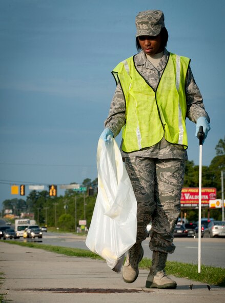 U.S. Air Force Airman 1st Class Brittney Jones, 23rd Wing Legal Office military justice paralegal, walks along the road outside of Moody Air Force Base, Ga., as she collects trash during a Pride Patrol June 28, 2011. The patrol is a weekly voluntary event that rotates between squadrons on base and helps keep Moody’s property line trash- and debris-free. (U.S. Air Force photo by Senior Airman Benjamin Wiseman/Released) 