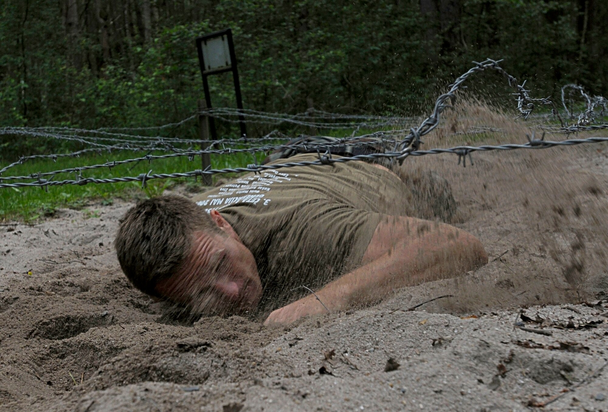 Slovenian army Pvt. Matic Repina crawls under barbed wire during an obstacle course competition June 23, 2011, as part of Allied Strike at Grafenwoehr Training Area, Germany. (U.S. Air Force photo/Airman 1st Class Desiree W. Esposito)