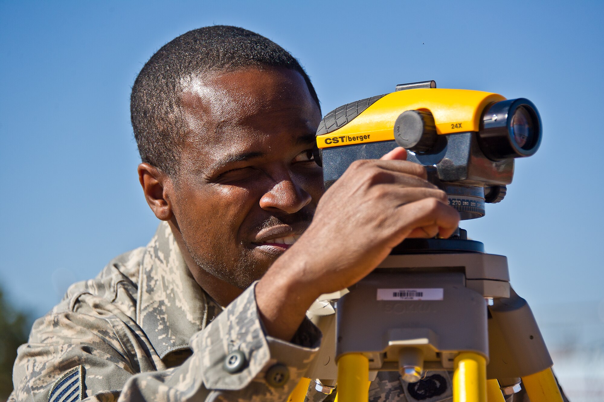 Tech. Sgt. Antonio Adolphues, 116th Civil Engineering Squadron, Robins Air Force Base, Ga., use an auto level to take measurements during a construction project at St. Michaels Association for Special Education, Window Rock, Ariz., June 9, 2011.  Adolphues and more than 40 members of his squadron performed work for the Navajo Nation as a part of the Department of Defense Innovative Readiness Training program. (U.S. Air Force photo by Master Sgt. Roger Parsons/Released)