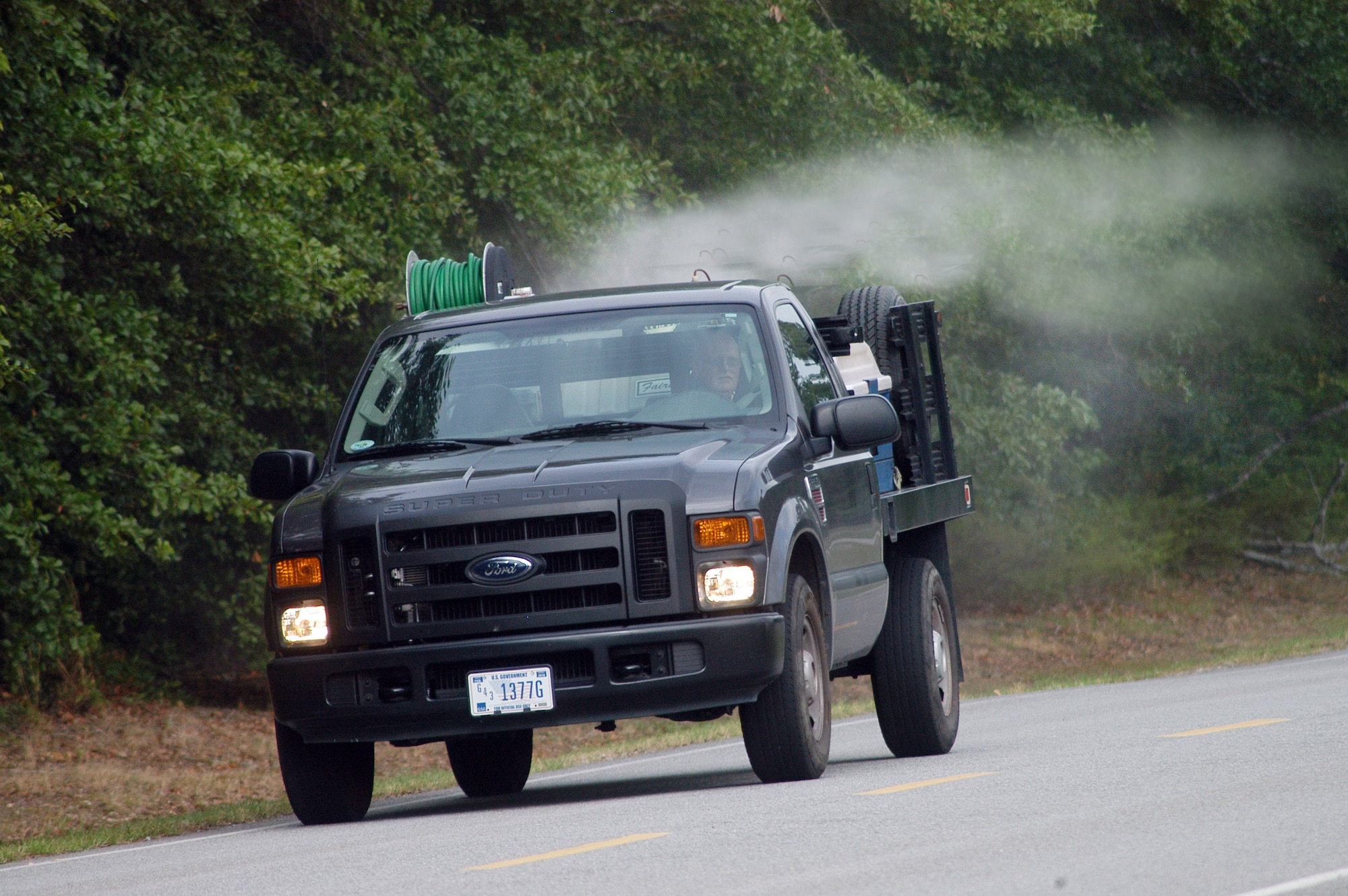 John Rourke, pest control technician,  sprays for adult mosquitoes. U. S. Air Force photo by Sue Sapp