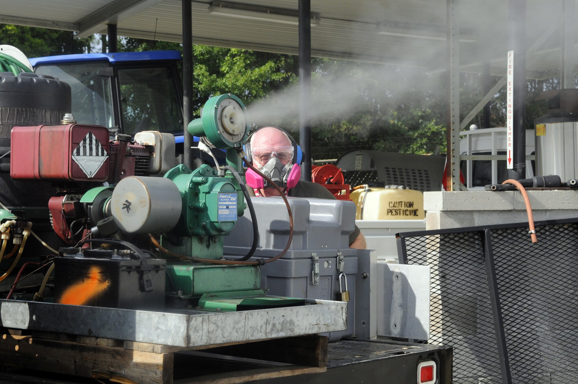 John Rourke, pest control technician, gets the fogging truck ready to spray for adult mosquitoes. U. S. Air Force photo by Sue Sapp
