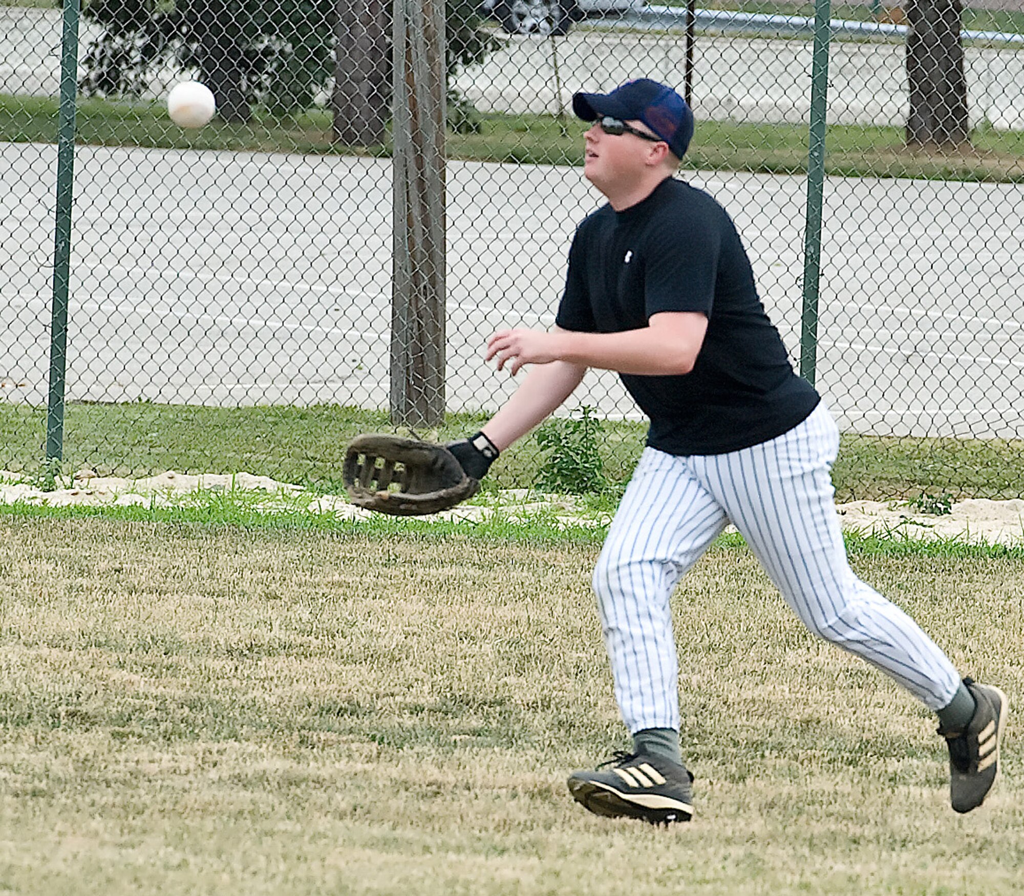Ryan Gray, 436th Medical Group outfielder, attempts to catch a pop fly June 23, 2011, at Dover Air Force Base, Del. The Medical Group was defeated by their opponent, the 436 Maintenance Squadron A team, 3 ? 10. (U.S. Air Force photo by Senior Airman Matthew Hubby)