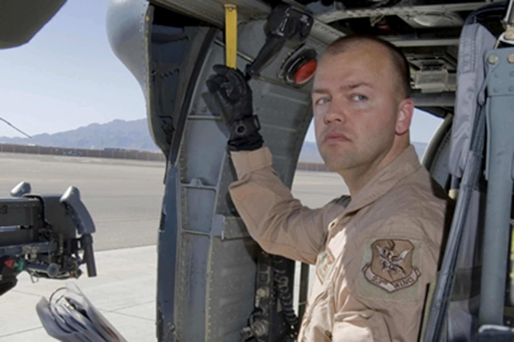 Staff Sgt. David Mullikin conducts a preflight check on an HH-60 Pave Hawk June 23, 2011, at Nellis Air Force Base, Nev. Sergeant Mullikin is a flight engineer assigned to the 66th Rescue Squadron. He returned from a tour in Iraq suffering from post-traumatic stress disorder and got help through the Air Force Wounded Warrior program. (U.S Air Force photo/Senior Airman Stephanie Rubi) 