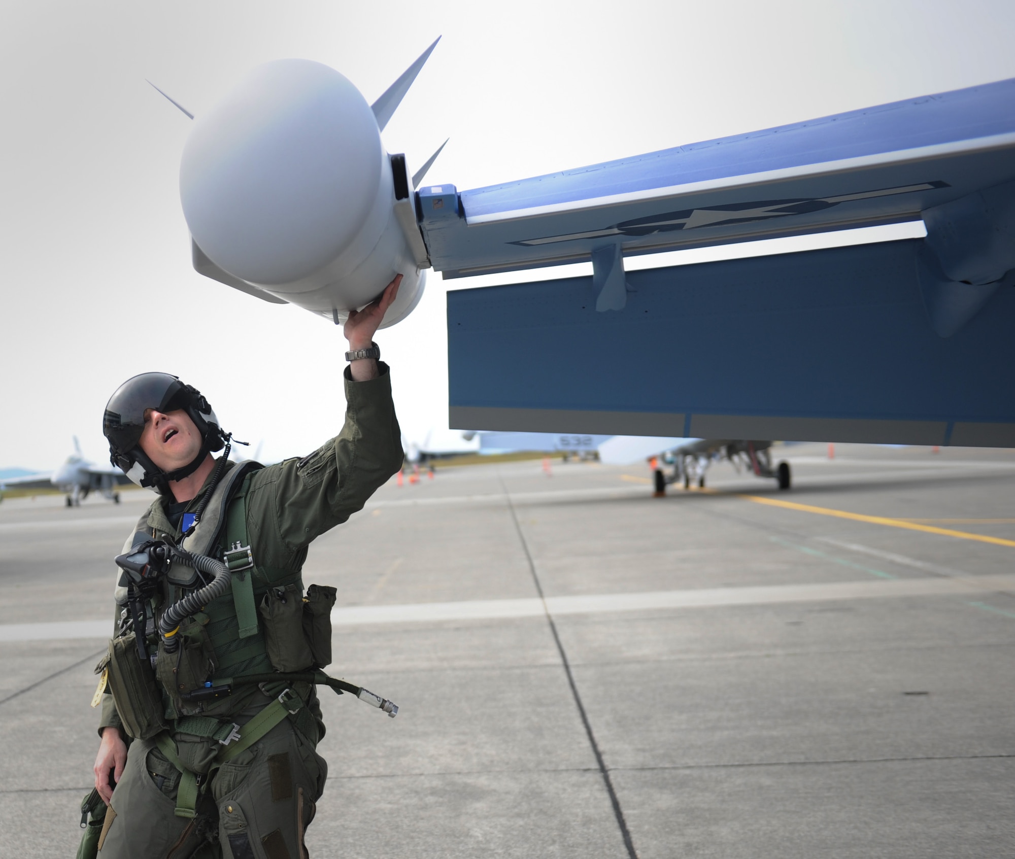 NAVAL AIR STATION WHIDBEY ISLAND, Wash. – Capt. Cole Davenport performs a pre-flight check on an EA-18G Growler here June 9. The Growler is the newest electronic warfare aircraft and is replacing the EA-6B Prowler. (U.S. Air Force photo by Staff Sgt. Gina Chiaverotti-Paige)
