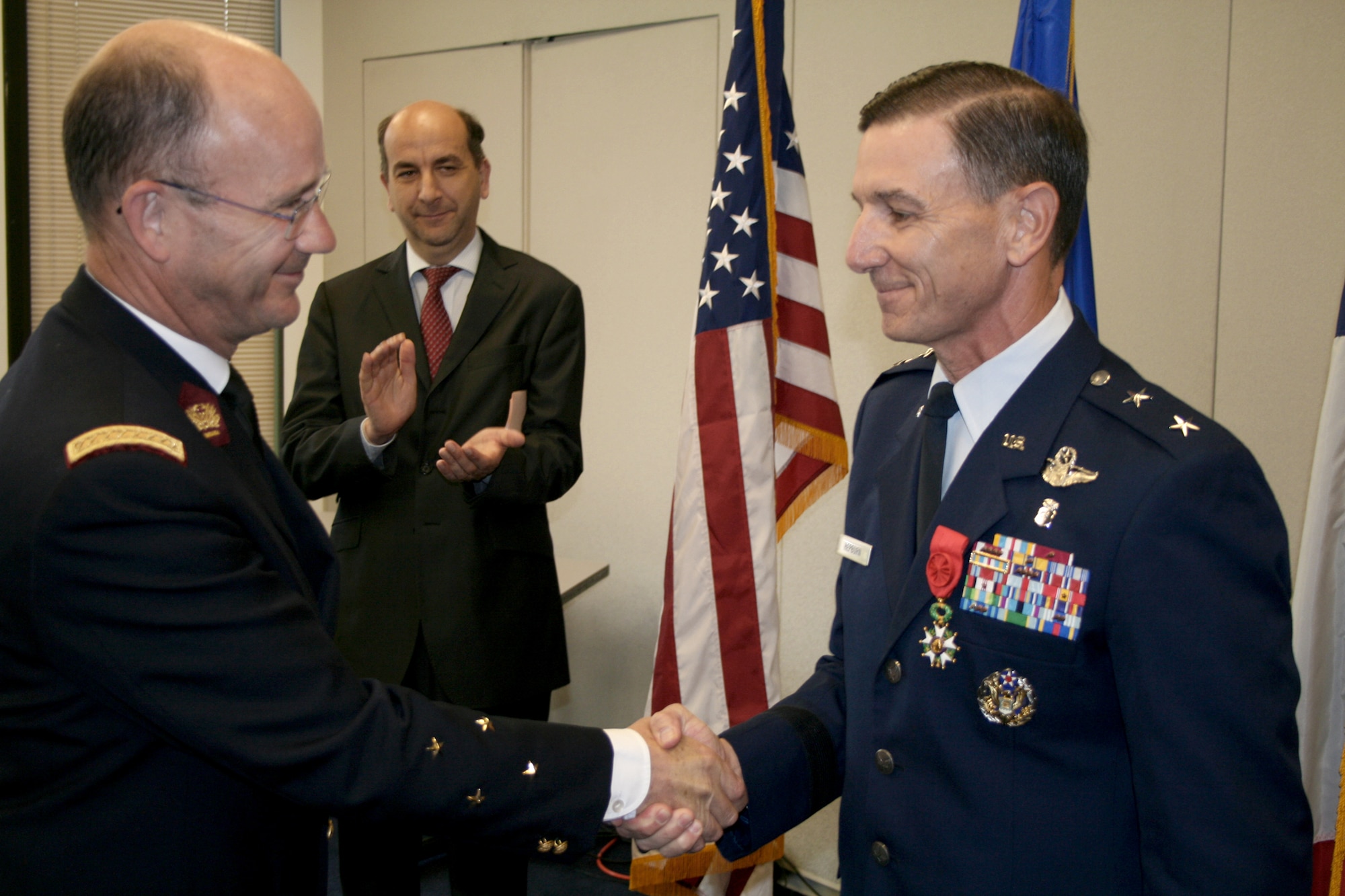 French Lt. Gen. Gérard Nedellec (left) shakes hands with Maj. Gen. (Dr.) Byron L. Hepburn, after pinning on the French Legion of Honor during a ceremony at the French Embassy in Washington June 21, 2011. General Nedellec is the French armed forces surgeon general and commander of the French Military Health Service. General Hepburn is the commander of the 59th Medical Wing in San Antonio.  (U.S. Air Force photo)