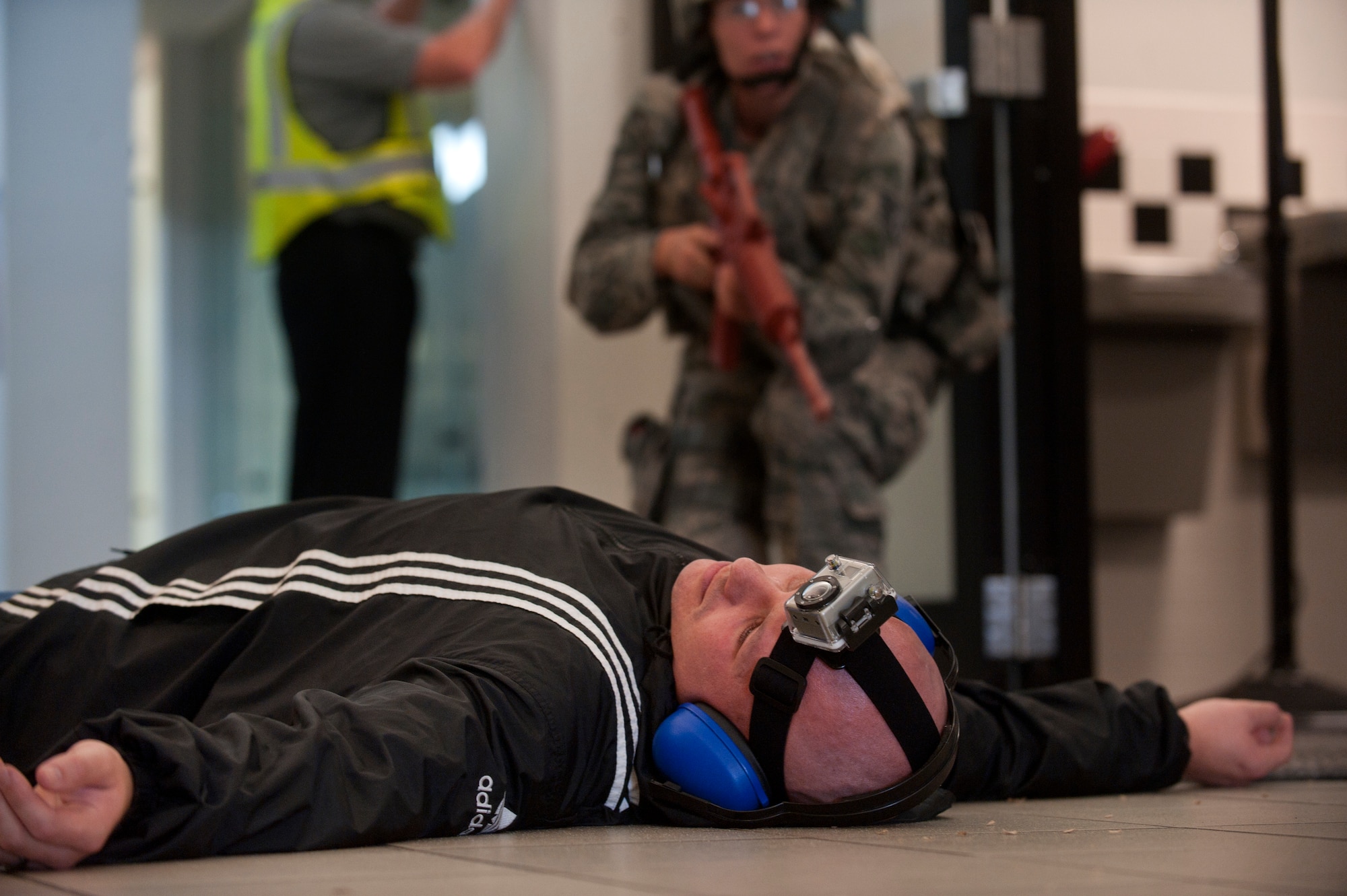 U.S. Air Force Tech Sgt. Clint Ellis, 23rd Security Forces Squadron plans and programs NCO in-charge, lies “dead” as a security forces member approaches to secure his body during an active shooter exercise June 24, 2011, at Moody Air Force Base, Ga. Emergency medical personnel moved in to help the wounded after the area was secured. (U.S. Air Force photo by Airman 1st Class Jarrod Grammel/Released)
