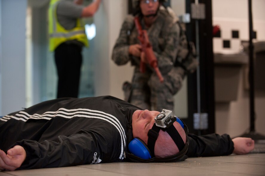 U.S. Air Force Tech Sgt. Clint Ellis, 23rd Security Forces Squadron plans and programs NCO in-charge, lies “dead” as a security forces member approaches to secure his body during an active shooter exercise June 24, 2011, at Moody Air Force Base, Ga. Emergency medical personnel moved in to help the wounded after the area was secured. (U.S. Air Force photo by Airman 1st Class Jarrod Grammel/Released)
