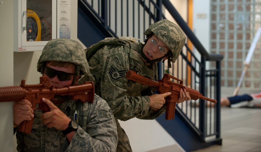 U.S. Air Force Staff Sgt. Jennifer Hall 23rd Security Forces Squadron patrolman (right), communicates to Senior Airman Chandler Kramer, 23rd SFS patrolman, on the suspected location of a gunman during an active shooter exercise June 24, 2011, at Moody Air Force Base, Ga. Airman Kramer made the shot that “killed” the gunman. (U.S. Air Force photo by Airman 1st Class Jarrod Grammel/Released)
