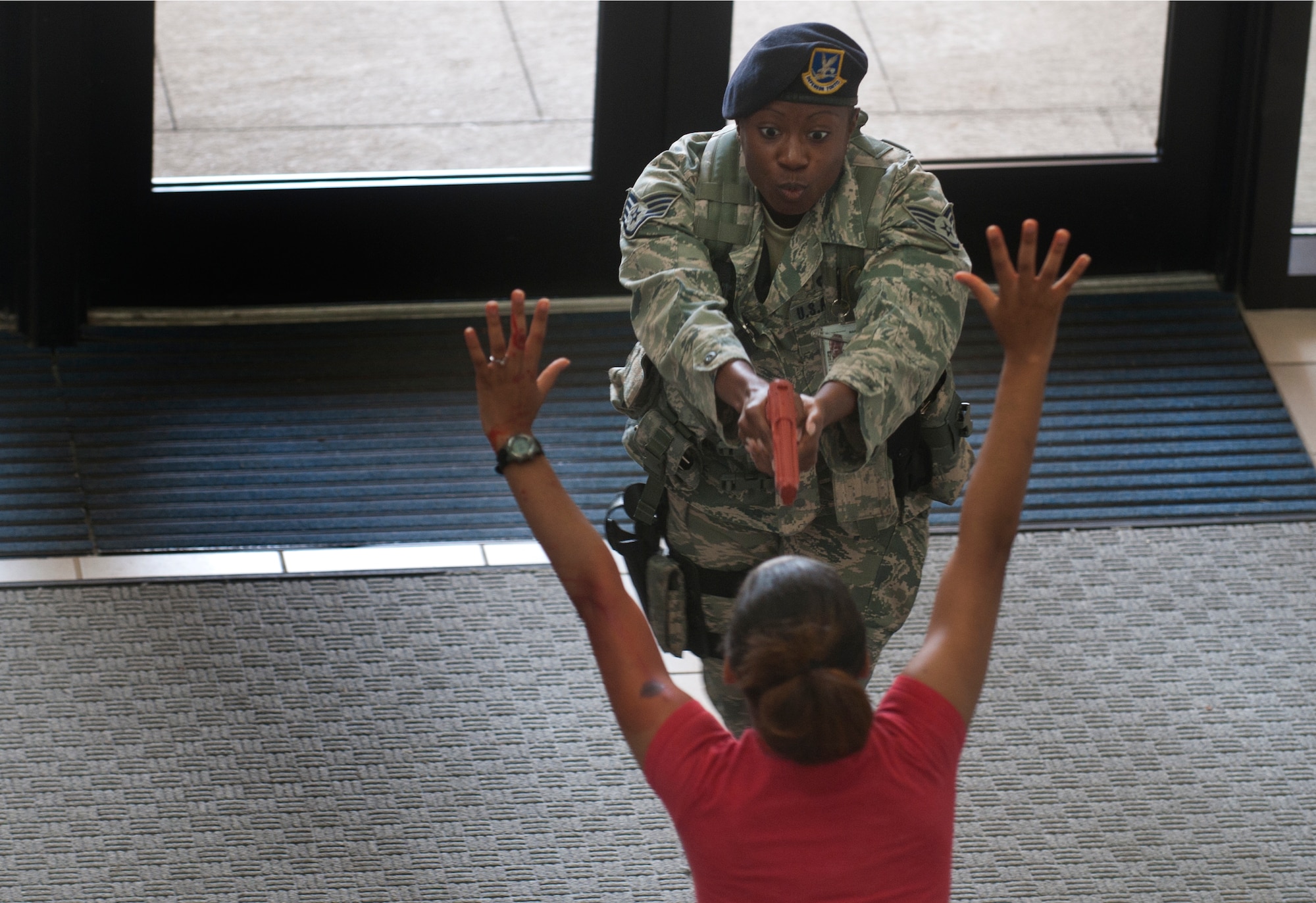 U.S. Air Force Staff Sgt. Ashley Darden, 23rd Security Forces Squadron security forces leader, gives instructions to a victim shortly after entering the Freedom I Fitness Center during an active shooter exercise June 24, 2011, at Moody Air Force Base, Ga. Sergeant Darden and her partner were the first responders to enter the building. (U.S. Air Force photo by Airman 1st Class Jarrod Grammel/Released)
