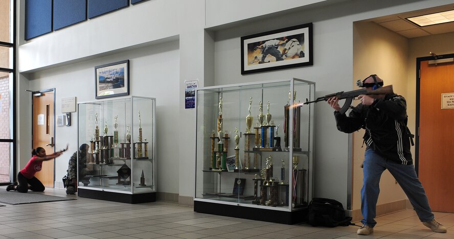 U.S. Air Force Tech. Sgt. Clint Ellis, 23rd Security Forces Squadron plans and programs NCO in-charge, fires off a few rounds after taking over the Freedom I Fitness Center at Moody Air Force Base, Ga., during an exercise June 24, 2011. Sergeant Ellis played the role of an active shooter. The intent of the exercise was to evaluate how well the base responds to an active shooter incident. (U.S. Air Force photo by Senior Airman Stephanie Mancha/Released)