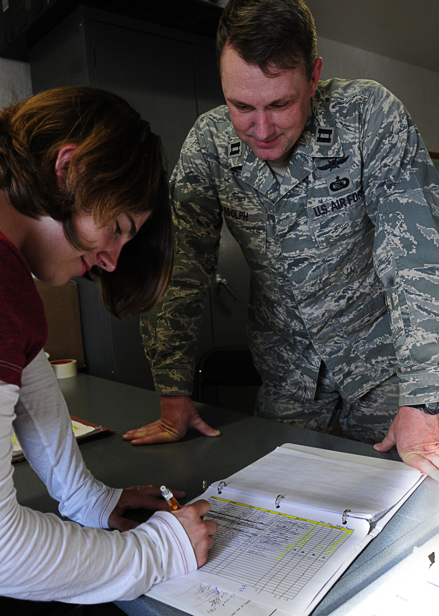 Capt. Phil Adolph, Allied Strike mayor cell co-director from the 4th Air Support Operations Group, directs Senior Airman Ashley Carpenter, 7th Weather Squadron, through the proper procedures for signing in, June 26, 2011. The mayor cell team provides food, billeting, and other logistical needs for nearly 350 U.S. and NATO servicemembers participating in Allied Strike 2011 in Grafenwoehr, Germany. (U.S. Air Force photo by Airman 1st Class Desiree W. Esposito)