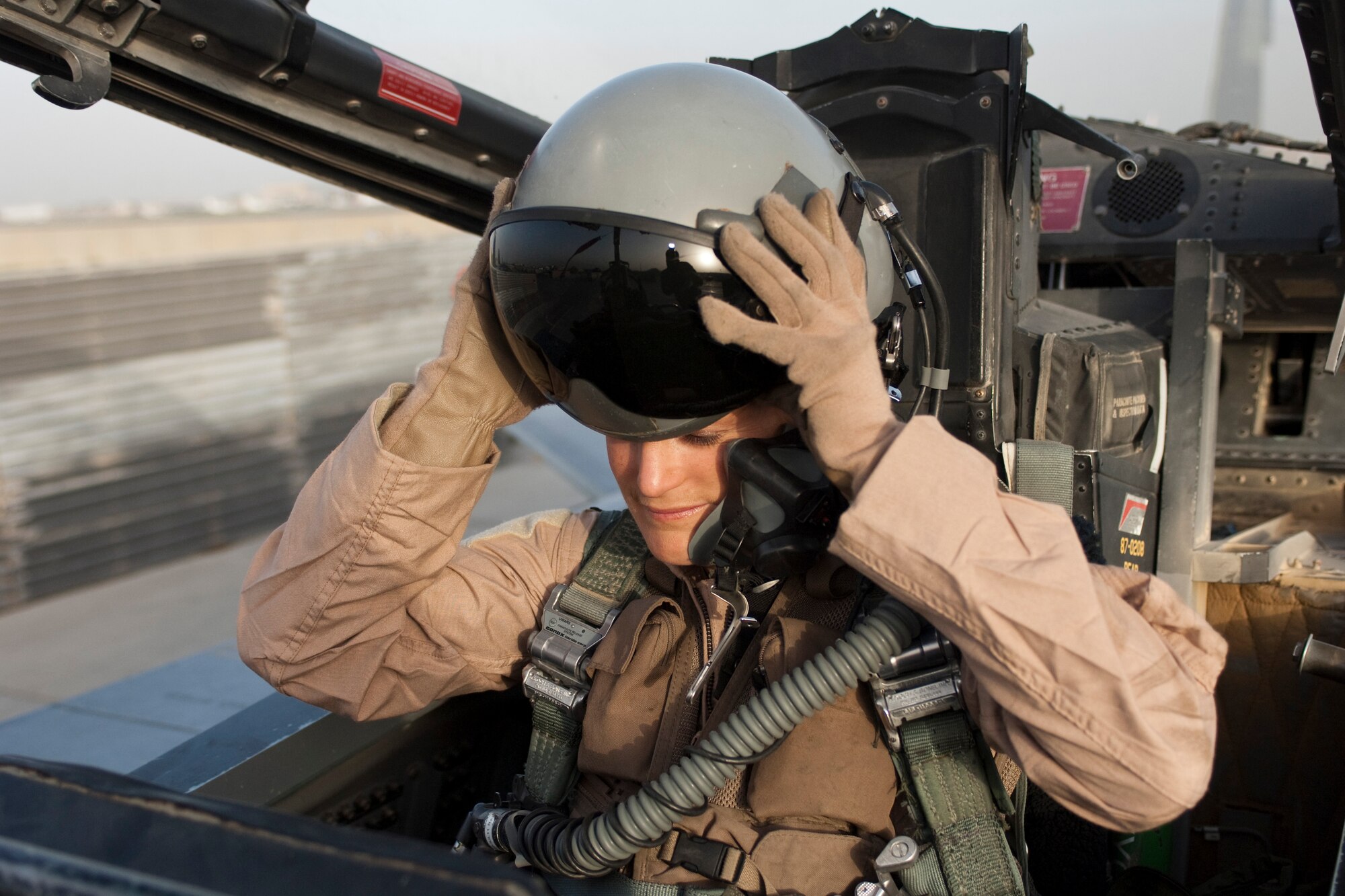 BAGRAM AIRFIELD, Afghanistan -- Capt. Leigh “Breaker” Larkin, a weapons system officer from the 389th Fighter Squadron here, puts her helmet on in preparation for a mission in an F-15E Strike Eagle here June 28. Captain Larkin was recently named one of four Airmen to receive the 2010 Mackay Trophy for her part in a combat mission near Turkmenistan April 6, 2010. The award is administered by the United States National Aeronautic Association and is awarded yearly by the United States Air Force for the "most meritorious flight of the year" by an Air Force person, persons, or organization. (U.S. Air Force photo by Staff Sgt. Jorge Intriago)