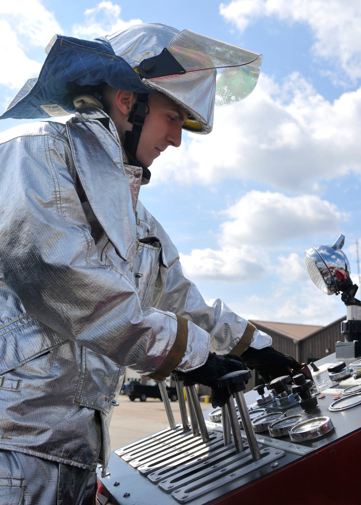 ROYAL AIR FORCE LAKENHEATH, England - Airman 1st Class Seth Arbogast, 48th Civil Engineer Squadron driver operator, adjusts the water pressure for the fire hose during a training session in the back of a fire truck, June 24, 2011. The 48th CES firefighters train routinely to remain proficient in their response to emergencies. They also provide tours to British nationals, train for firefighter challenges, perform extrication demonstrations, provide fire prevention training and perform other duties. (U.S. Air Force photo/Senior Airman Tiffany M. Deuel)