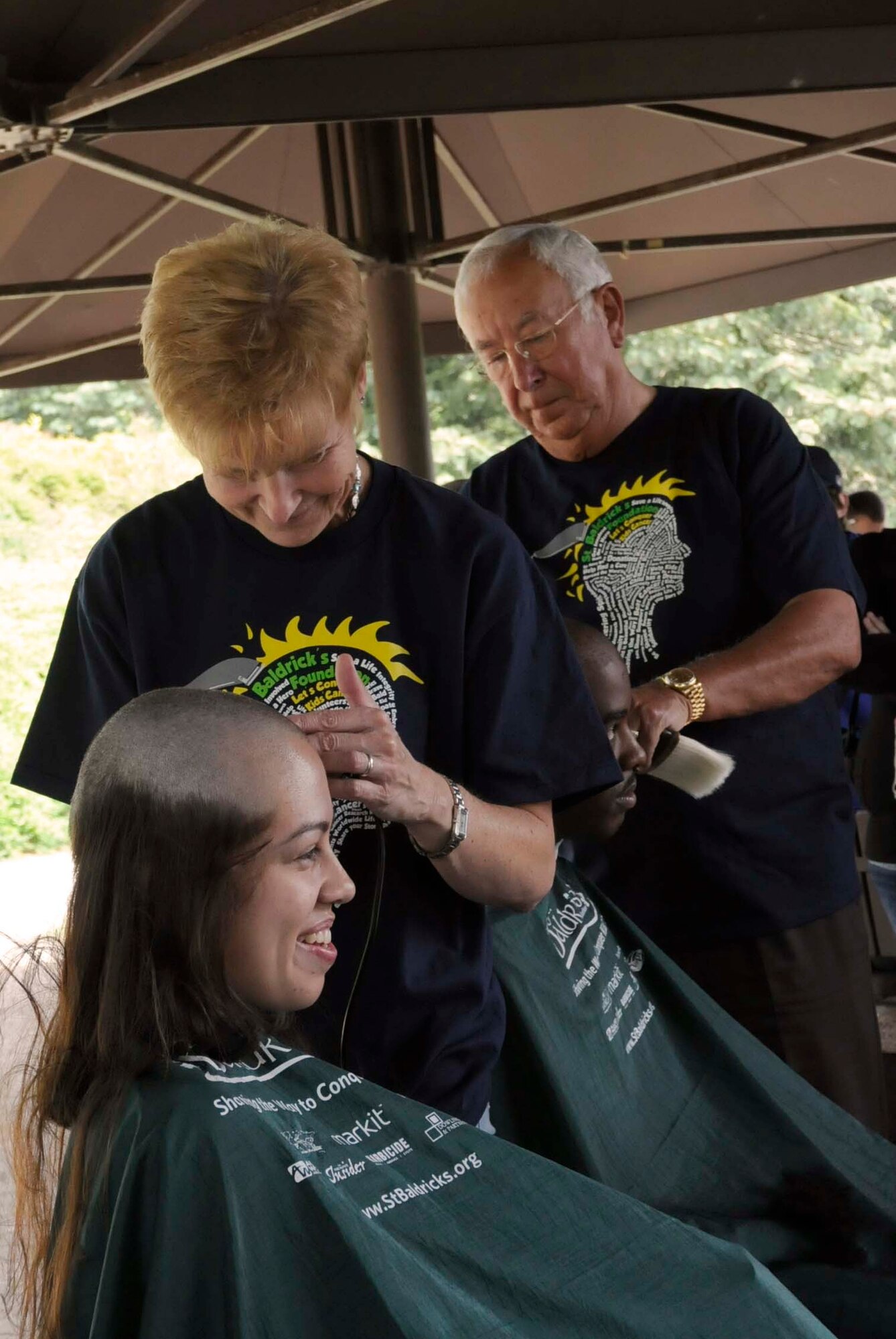 Tracy Alejandro, wife of U.S. Air Force Senior Airman Dexter Alejandro, 786 Force Support Squadron, gets her head shaved in participation of the second annual St. Baldricks event on Ramstein Air Base, Germany, June 26, 2011. The St. Baldricks Foundation is an organization that tasks volunteers with getting sponsored to have their heads shaved as a demonstration of their camaraderie to children that have been diagnosed with cancer. (U.S. Air Force photo by Airman 1st Class Kendra Alba)