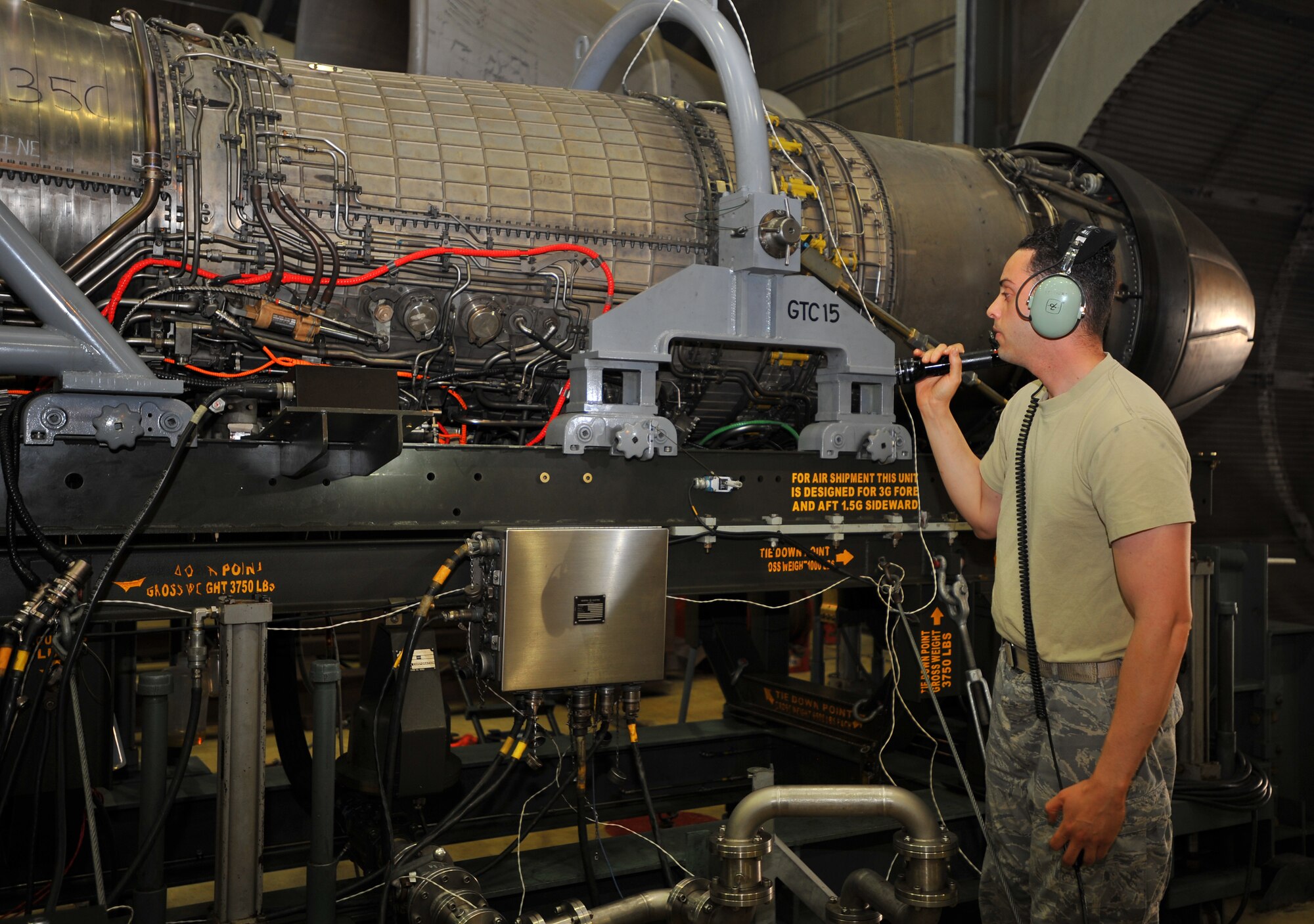 SPANGDAHLEM AIR BASE, Germany – Staff Sgt. Jose Torres Silva, 52nd Component Maintenance Squadron, inspects a jet engine for fluid leaks during testing inside the hush house here June 27. The hush house is a sound controlled hangar used to test turbine engines for malfunctions before they are mounted on aircraft. (U.S. Air Force photo/Airman 1st Class Dillon Davis)