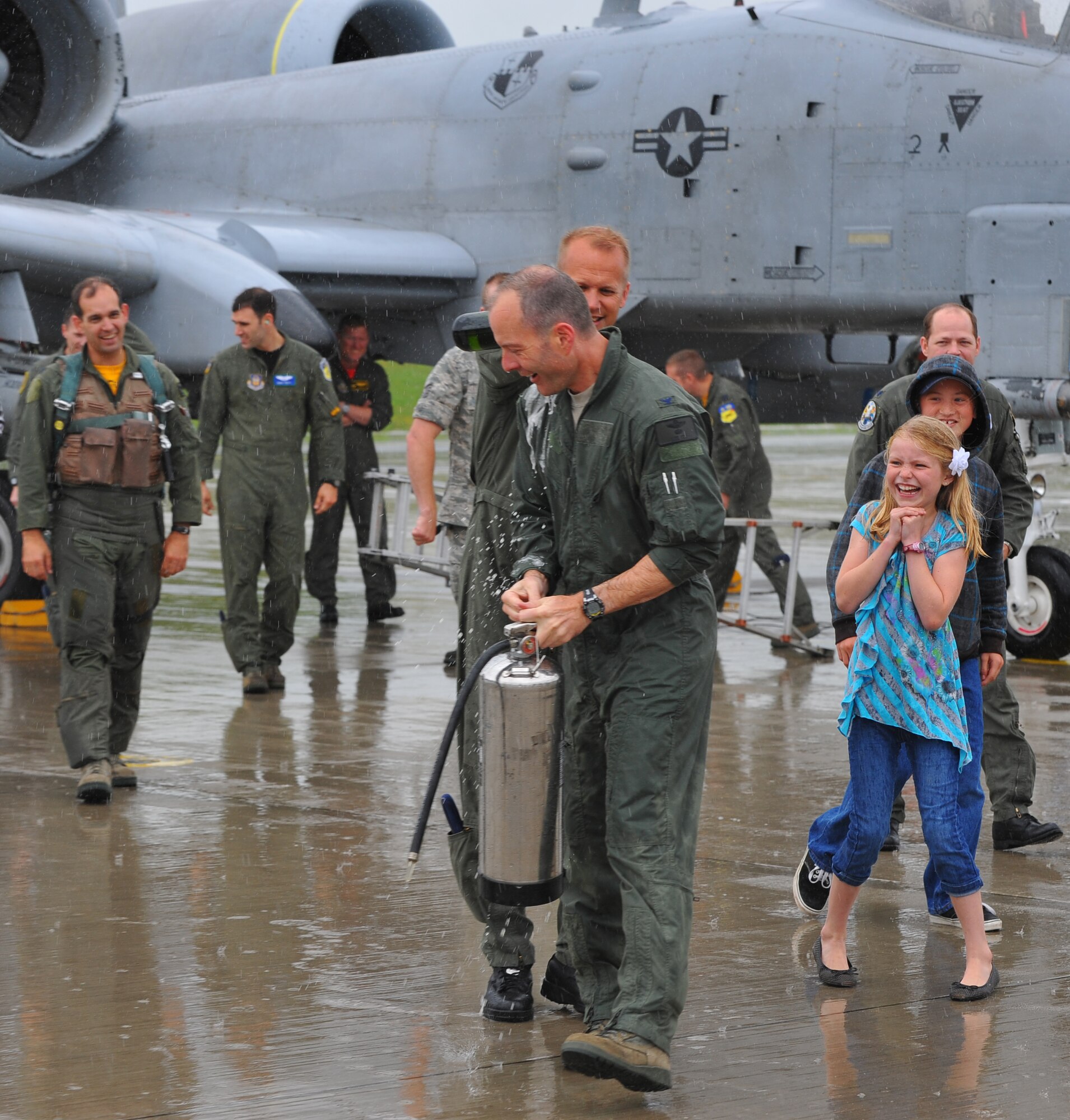 SPANGDAHLEM AIR BASE, Germany – Lt. Col. Geoffrey Maki, 52nd Operations Group, pours sparkling wine on Col. Jackson Fox, 52nd Operations Group commander, after his final flight here June 24. Colonel Fox celebrated his last A-10 Thunderbolt II flight at Spangdahlem Air Base with family, friends and coworkers before taking command of the 39th Air Base Group at Incirlik Air Base, Turkey. (U.S. Air Force photo/Airman 1st Class Dillon Davis)