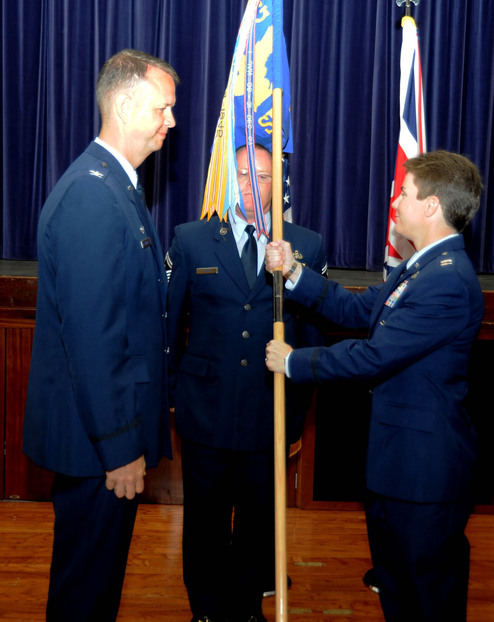 Captain Kelli Green hands off the guidon after assuming command of the 422nd Security Forces Squadron at RAF Croughton June 27.