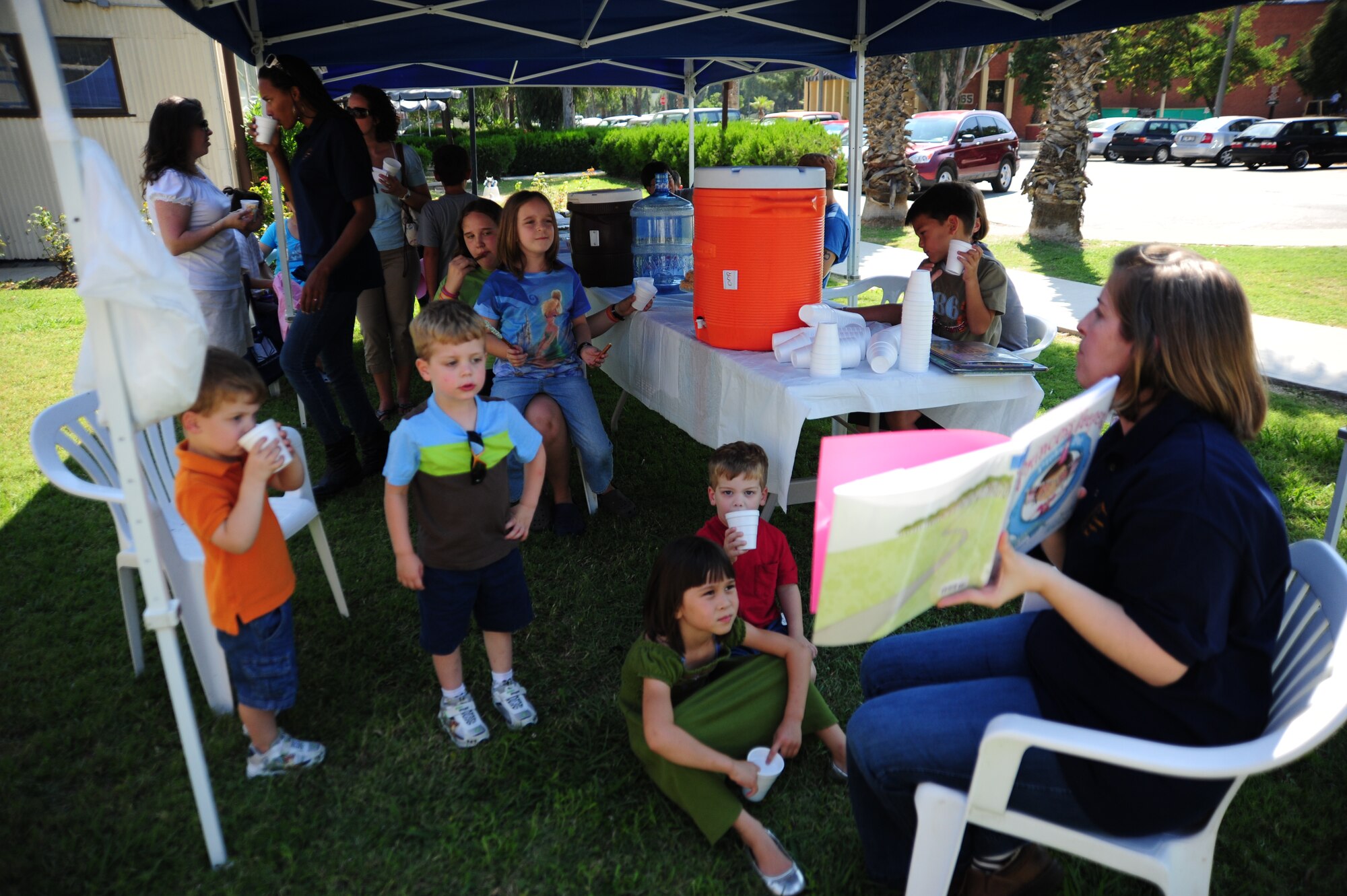 Sara Sesker, wife of Tech. Sgt. Gail Sesker, 39th Communications Squadron airfield systems technician, reads to children during the Summer Reading Kick-Off event June 24, 2011, at Incirlik Air Base, Turkey.  The reading event was a way for children to celebrate summer reading and receive encouragement to read through the summer. (U.S. Air Force photo by Senior Airman Anthony Sanchelli/Released)