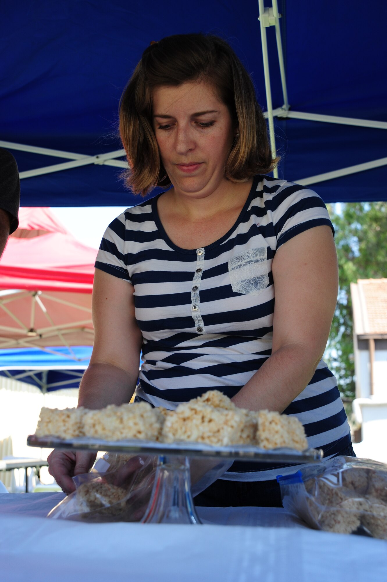 Sara Sesker, wife of Tech. Sgt. Gail Sesker, 39th Communications Squadron airfield systems technician, sets out treats for participants to eat during the Summer Reading Kick-Off event June 24, 2011, at Incirlik Air Base, Turkey.  The reading event was a way for children to celebrate summer reading and receive encouragement to read through the summer. (U.S. Air Force photo by Senior Airman Anthony Sanchelli/Released)