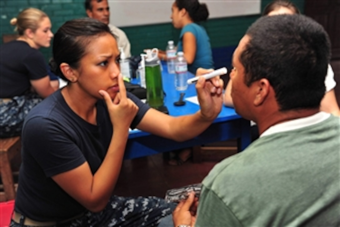U.S. Navy Lt. Patricia Salazar (left), an optometrist, checks a patient's vision at the Humberto Mendez Rivas medical site during Continuing Promise 2011 in Rivas, Nicaragua, on June 24, 2011.  Continuing Promise is a regularly scheduled mission to countries in Central, South America and the Caribbean, where the U.S. Navy and its partnering nations work with host nations and a variety of governmental and nongovernmental agencies to train in civil-military operations.  
