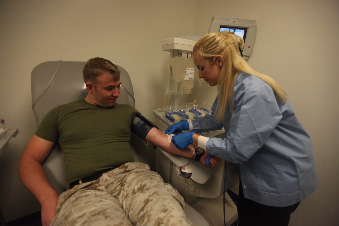 Petty Officer 2nd Class Joshua Gibson, a corpsman with Naval Hospital Camp Lejeune, aboard Marine Corps Base Camp Lejeune, watches patiently as Stephanie Howard, a medical lab technician with NHCL prepares him for a platelet donation, June 29. The Armed Services Blood Program looks for donors who are willing to donate blood and platelets which will be used to help service members throughout the world, be it Afghanistan or Camp Lejeune.