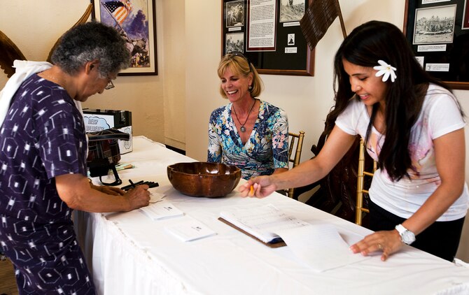 A guest at the Sunset Lanai enters a prize drawing during the grand re-opening of the club here June 29. The grand prize was a free weekend at the Sheraton Waikiki.