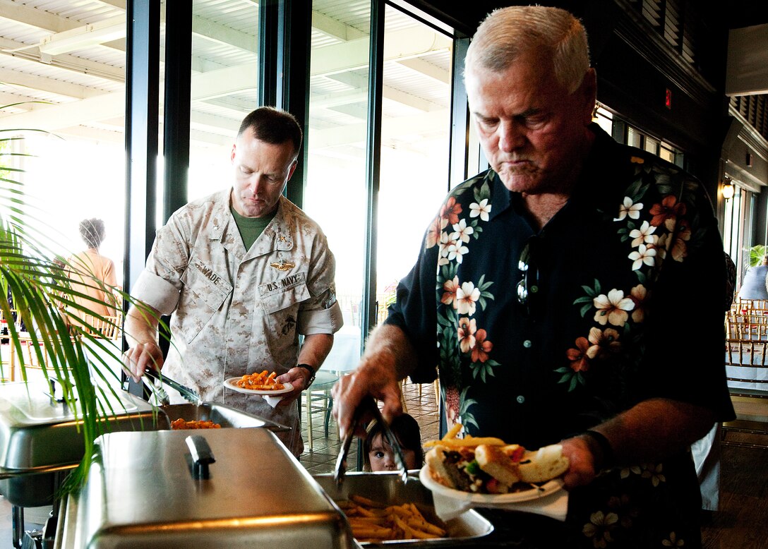 Guests take advantage of the free appetizers during the Sunset Lanai’s grand re-opening celebration here June 29. The club provided the free pupus to advertise their new bar menu, available Wednesday and Friday evenings.