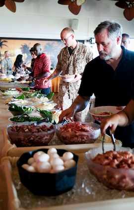 Guests at the Sunset Lanai, the all-hands club next to Bordelon Field here, serve themselves Mongolian barbecue during the grand re-opening celebration June 29. The club has the barbecue available every Wednesday evening.