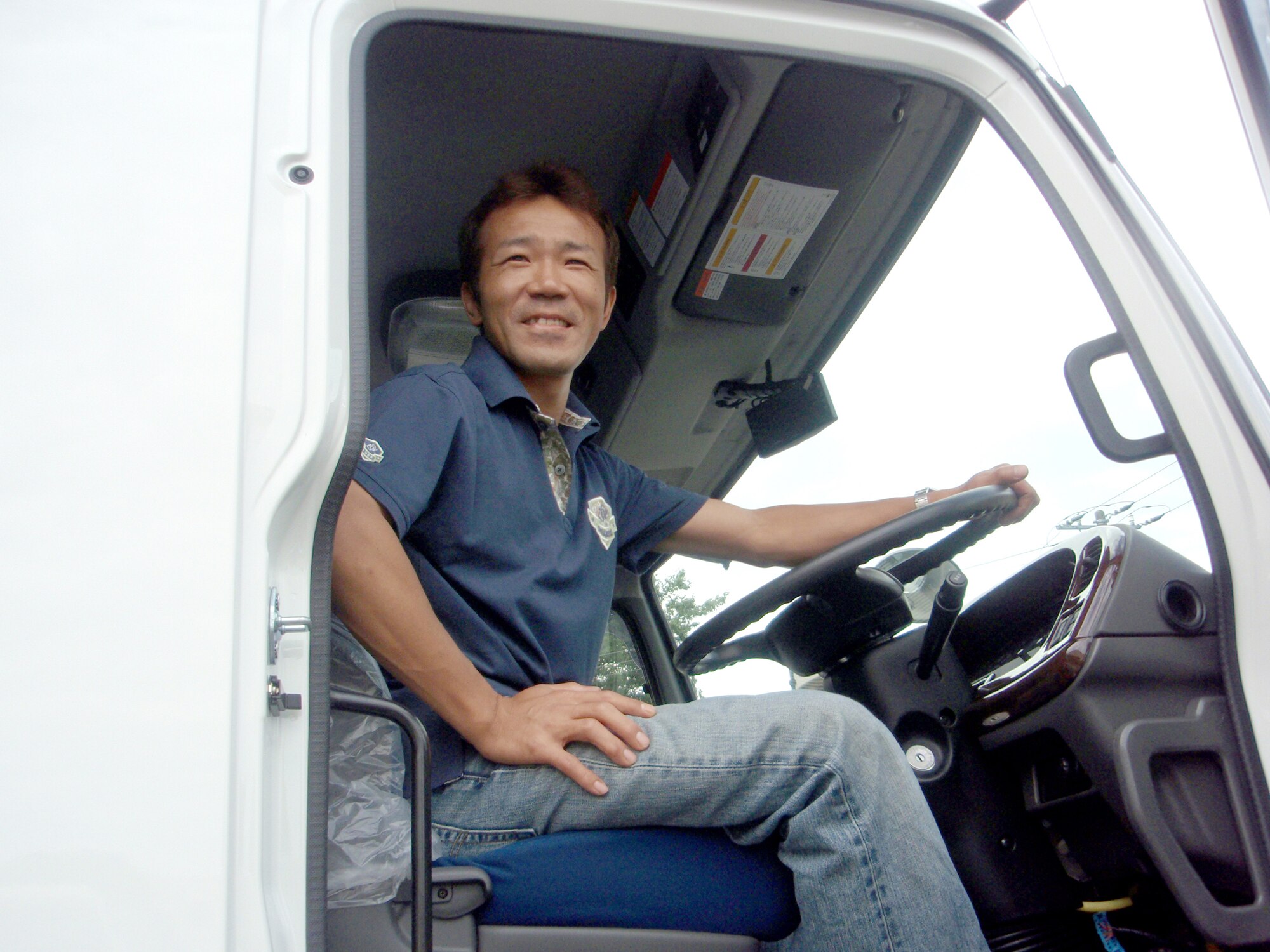 YOKOTA AIR BASE, Japan -- Masaaki Tanaka, an Army and Air Force Exchange Service heavy vehicle driver, sits behind the wheel of his truck June 23 at the Exchange's Japan Distribution Center located at Yokota. Tanaka, who was recently named the Exchange Pacific Region Driver of the Year, has logged more than 109,000 accident-free miles while delivering merchandise to Exchange facilities throughout mainland Japan. (Photo courtesy of Chika Nakajima, Exchange Japan Distribution Center)