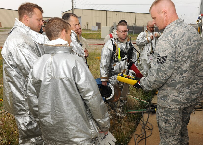 KUNSAN AIR BASE, Republic of Korea -- Tech. Sgt. Matthew Reichle, 8th Civil Engineer Firefighter, explains to base leadership how training is conducted when putting out fires here June 27. Training is important because it ensures firefighters are always constant in their abilities. (U.S. Air Force photo/Senior Airman Ciara Wymbs)