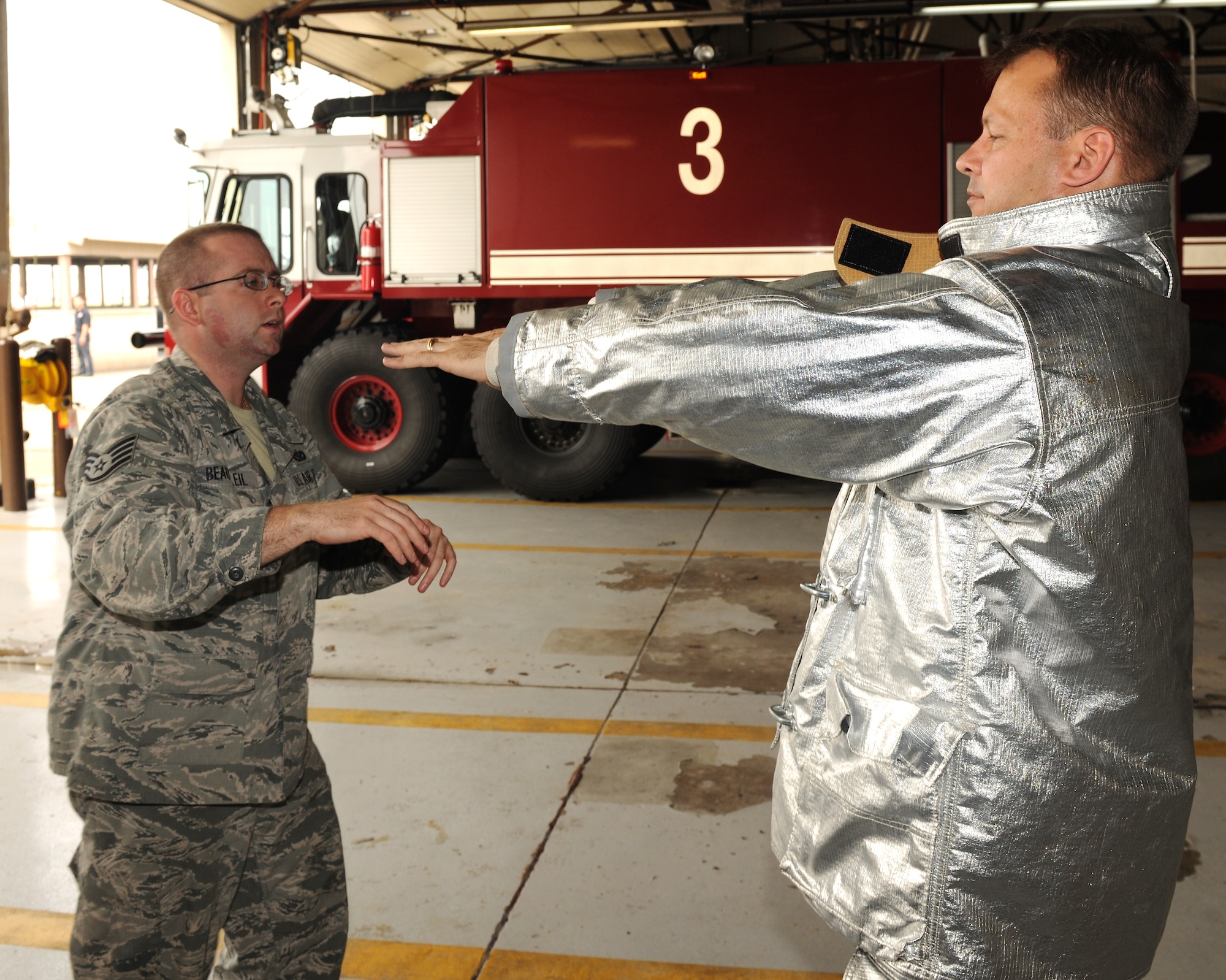 KUNSAN AIR BASE, Republic of Korea -- Staff Sgt. Vincent Beausoleil, 8th Civil Engineer Squadron firefighter, ensures a fire proximity suit fits here June 27. The suits are designed to protect firefighters from high temperatures, especially near fires of extreme temperatures such as aircraft fires. (U.S. Air Force photo/Senior Airman Ciara Wymbs)