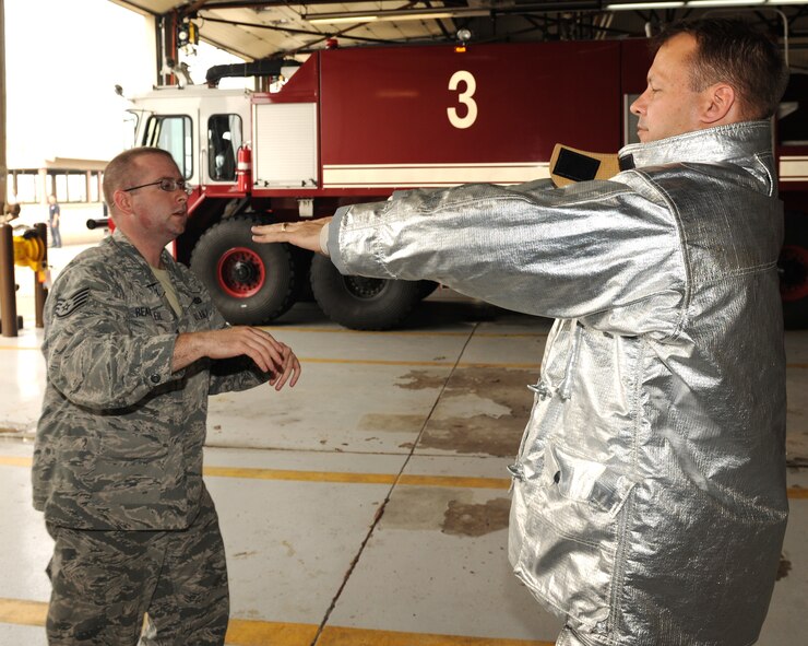 KUNSAN AIR BASE, Republic of Korea -- Staff Sgt. Vincent Beausoleil, 8th Civil Engineer Squadron firefighter, ensures a fire proximity suit fits here June 27. The suits are designed to protect firefighters from high temperatures, especially near fires of extreme temperatures such as aircraft fires. (U.S. Air Force photo/Senior Airman Ciara Wymbs)