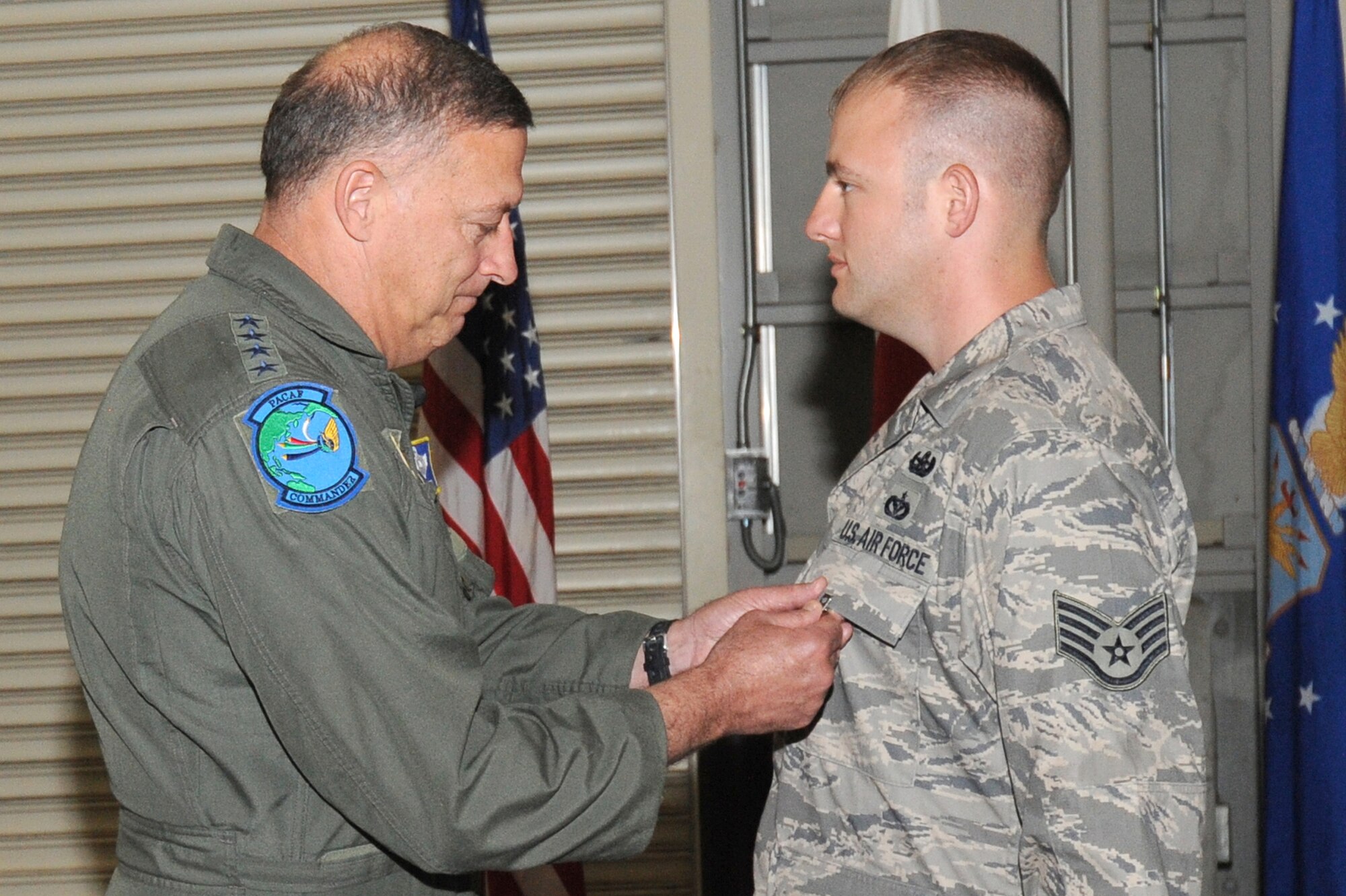 MISAWA AIR BASE, Japan -- Gen. Gary North, Pacific Air Forces commander, pins a Bronze Star medal onto Staff Sgt. Anthony Walling during his recent visit to Misawa Air Base June 27. Sergeant Walling earned the Bronze Star after his recent deployment to Afghanistan in support of Operation Enduring Freedom. (U.S. Air Force photo/Staff Sgt. April Quintanilla/Released)
